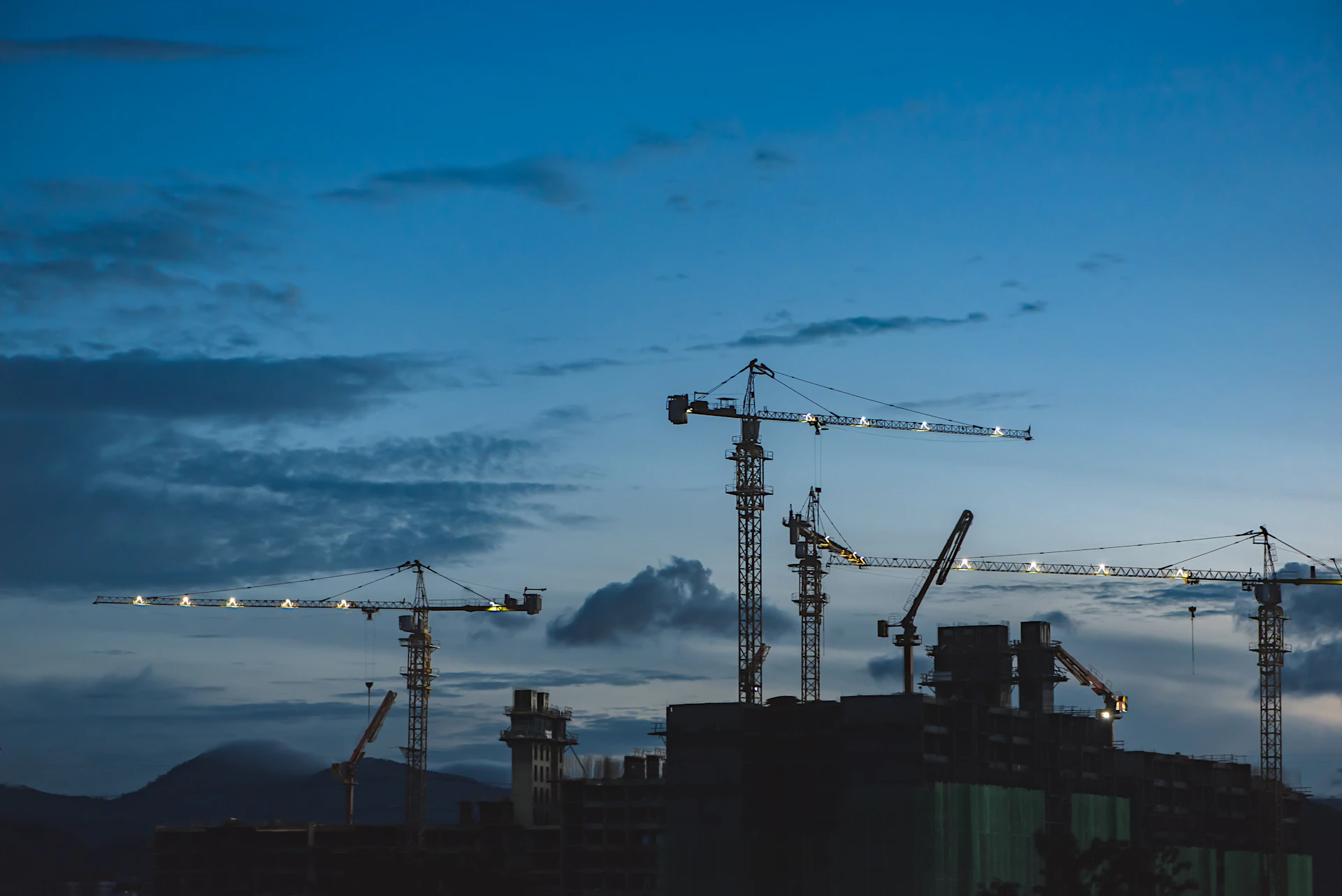 Cranes above buildings under construction
