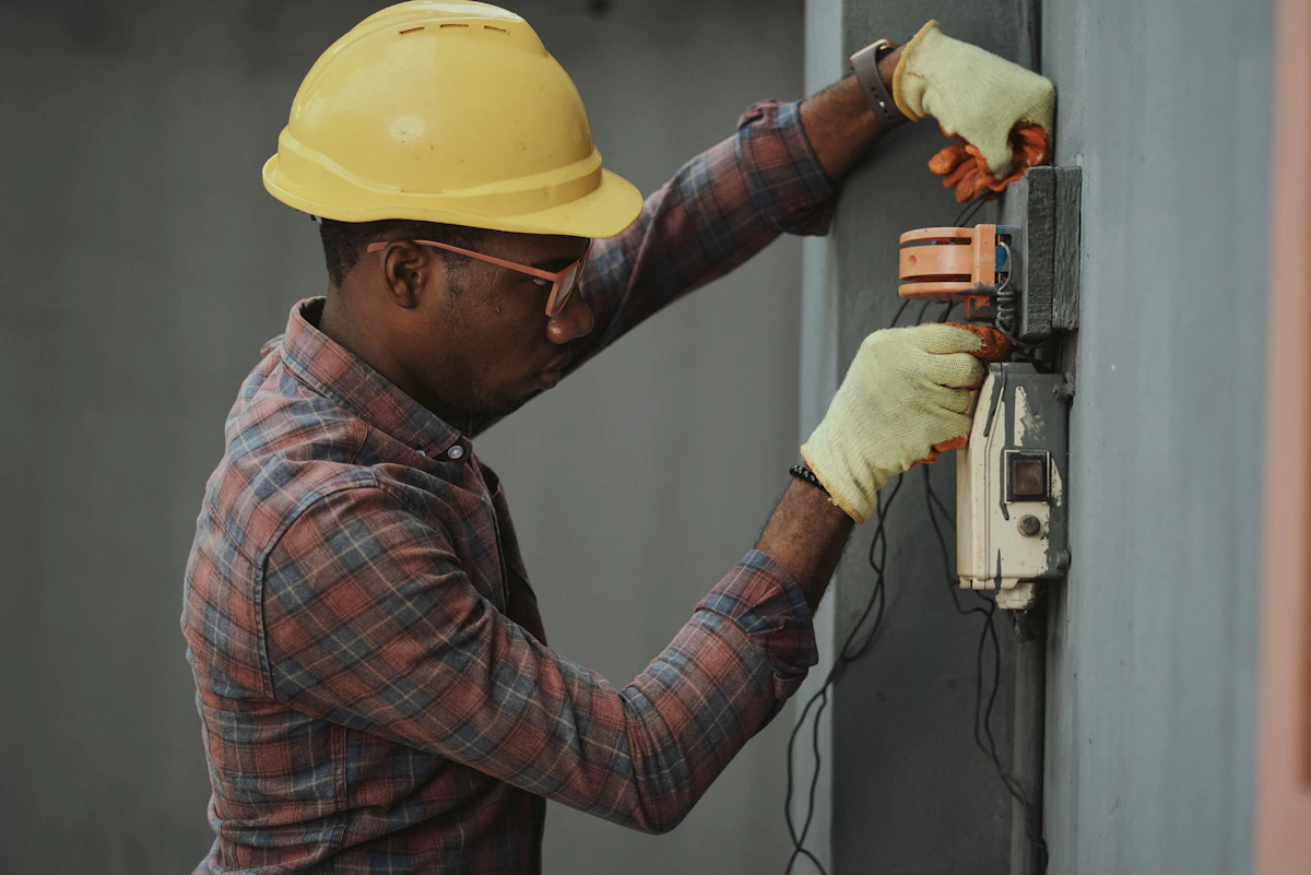 Electrician wiring a switch box on a wall