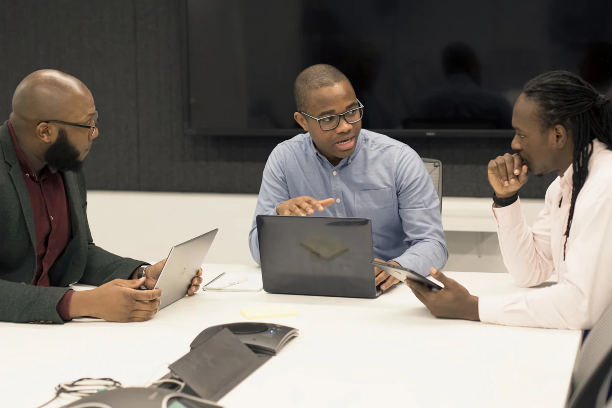 Team meeting around a table with laptops