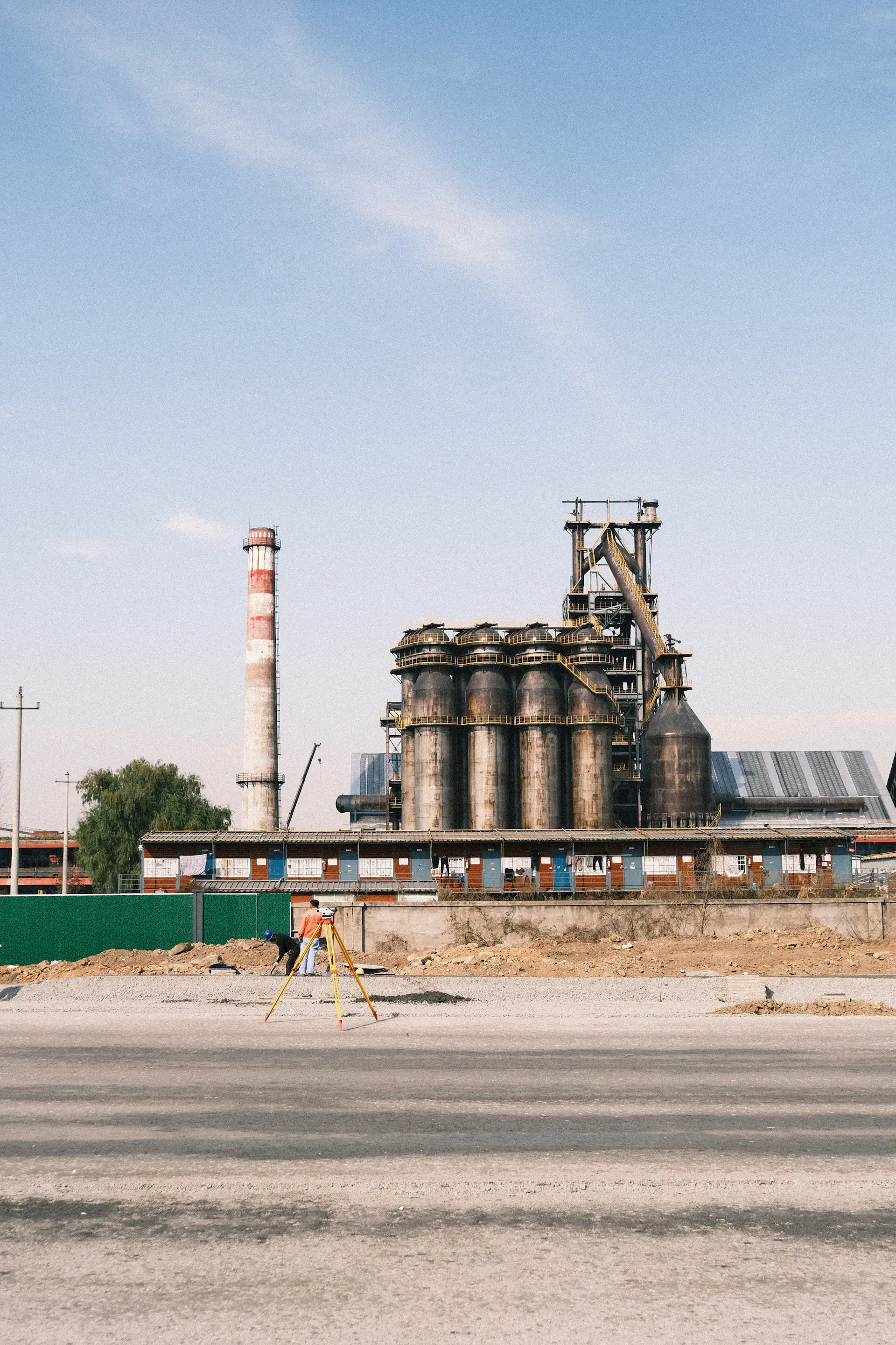 Industrial plant with a surveyor in the foreground